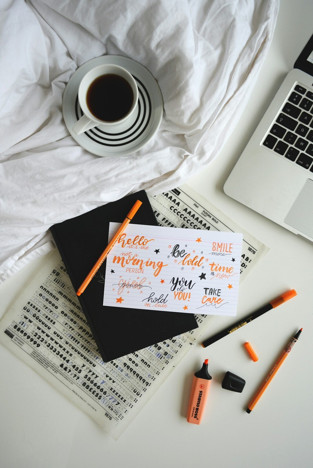 Handwritten notes and a fountain pen on a desk with coffee